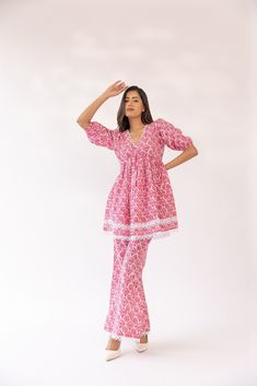 Featuring a pink & white block printed kurta set in cotton blend base detailed with lace edging. It is paired with matching flared pants. Color: PINK FABRIC: COTTON Delivery time 15 to 20 days Pink V-neck Anarkali Set, Bohemian Pink Palazzo Set With Chikankari Embroidery, Pink Bohemian Palazzo Set With Chikankari Embroidery, Bohemian Pink Sets With Block Print, Bohemian Pink Block Print Sets, Festive Cotton Sets With Lace Trim, Bohemian Pink Cotton Sets, Pink Cotton Block Print Set, Pink Cotton Sets With Block Print