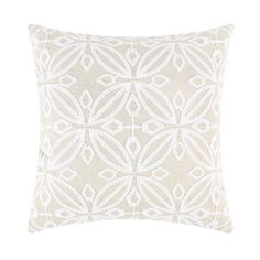 a white pillow with an intricate design on it