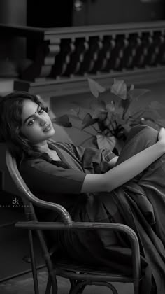 black and white photograph of a woman sitting in a chair