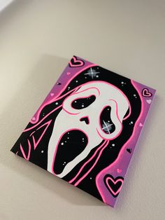 a pink and black painting on a white wall with hearts in the shape of a ghost