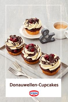 there are three cupcakes with cream and chocolate toppings on the plate next to each other