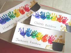 three handprinted name tags are sitting on a tray