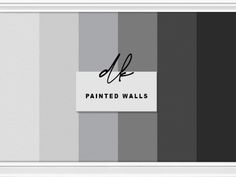 a white frame with a black and grey striped wallpaper behind it that says, painted walls