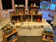 a candy bar is set up in the middle of a room with tables and chairs