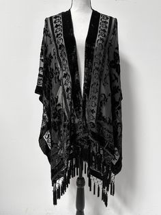 This shawl is absolutely LUSH...very reminiscent of fabulous piece from early 1900s. Would work beautiful over a nice dress or as a robe. The fabric is slightly sheer black base with an all over black velvet floral pattern and trim. All along the bottom is lovely diamond fringe to really seal the glamorous look of this piece. It is one size fits all (yes, really! S-5X) and does feature armholes for ease of wear. It is NOT at all fitted and it does have armholes and it functions more like a cape/ Soft Goth Glam Outfit, Dark Victorian Aesthetic Outfit, Dark Victorian Aesthetic, Goth Glam, Black Shawl, Glam Outfit, Shawl Cardigan, Clothing Hacks, Boho Look