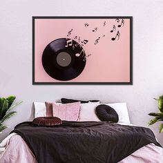 a bed with a black sheet on top of it and musical notes coming out of the disc