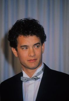 a young man wearing a suit and bow tie