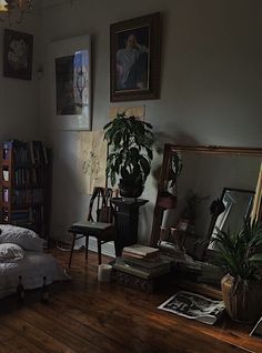 a bed sitting in a bedroom next to a tall wooden shelf with pictures on it