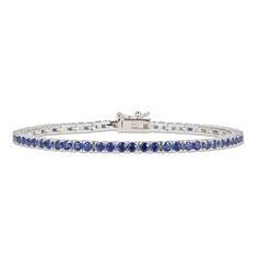 This elegant line bracelet is adorned with sumptuous round blue lab-created sapphires that shimmer within links of sterling silver. The bracelet measures 7.25 inches and secures with a box clasp. Classic Sapphire Diamond Bracelet, Classic Round Sapphire Diamond Bracelet, Blue Formal Tennis Bracelet, Formal Blue Tennis Bracelet, Blue Round Tennis Bracelet With Prong Setting, Classic Sapphire Tennis Bracelet With Prong Setting, Blue Tennis Bracelet With Prong Setting, Classic Blue Diamond Bracelet For Formal Occasions, Classic Sapphire Tennis Bracelet With Round Shape