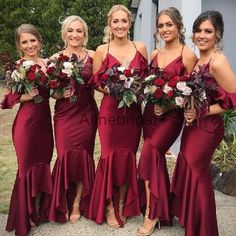 the bridesmaids are all wearing red dresses and holding bouquets in their hands