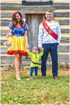 a man and woman holding hands with a small child