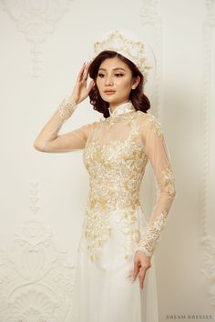 Elegance and grace take center stage with our Jiayi White Vietnamese Ao Dai, a timeless and enchanting choice for your special day. With an illusion neckline and back, this gown creates an ethereal and captivating aura. Long sleeves add a touch of classic beauty creating a sophisticated look. The exquisite couture lace adorns the entire ensemble, adding a luxurious and intricate touch. Embrace tradition and elegance in our Ao Dai, a gown that will make you feel like a vision of beauty on your wedding day Detail: White Vietnamese Ao Dai Collar: 1.4in/ 3.5cm Illusion neckline Illusion back Long sleeves Bra cups added Zipper closure White chiffon pants Sweep train (12''/30cm) Couture lace Made to order Fitted Lace Back Gown For Debutante Ball, White Ao Dai Wedding Dress, Fitted Gown With Illusion Neckline For Debutante Ball, Wedding Evening Dress With Sheer Back And Fitted Bodice, Elegant Lace Back Evening Dress For Wedding, Fitted Dress With Sheer Bodice For Ceremony, Fitted Wedding Gown With Lace Back, Fitted Wedding Dress With Sheer Back, Fitted Wedding Dress With Illusion Neckline For Debutante Ball