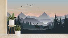 a wall mural depicting two deer in the mountains