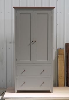 an armoire with two doors and three drawers