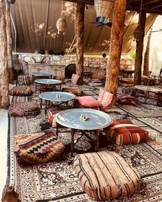 an outdoor seating area with colorful cushions and tables