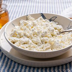 a bowl of cottage cheese with a spoon in it