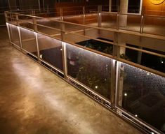 the inside of a building with metal railings and plants in pots on top of it