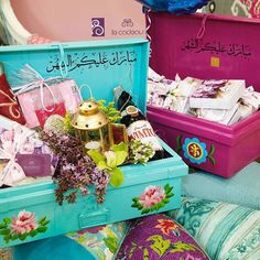 two colorful suitcases filled with lots of different types of items and decorations on display