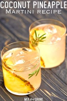 two glasses of coconut pineapple martini on a wooden table with rosemary garnish