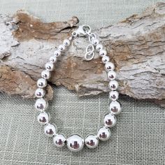 "Beautiful! Classy, simple everyday wear. Adjustable all shiny round ball sterling silver bead bracelet. Perfect  gift 🎁 for that special someone who you may not know their wrist size. Several bead sizes from 10mm - LARGE size bead - 5mm MEDIUM size beads   MEASURE WRIST: wrap string around wrist (not tight) see photo.  SUGGEST adding about 1/2\" to see which bracelet will work for you.  Length measured from clasp to extender link - NOT bead to bead  📌PLEASE SEE LAST PHOTO for what 7\" - 8\" l Classic Sterling Silver Bracelets With Spacer Beads, Minimalist Sterling Silver Bracelet With Spacer Beads, Classic Adjustable Sterling Silver Bracelet With Polished Beads, Classic Sterling Silver Beaded Bracelets With Polished Beads, Adjustable Hypoallergenic Sterling Silver Bracelet With Round Beads, Everyday Silver Bracelets With Polished Beads, Everyday Silver Bracelet With Polished Beads, Classic Sterling Silver Bracelet With Polished Beads As Gift, Classic Sterling Silver Polished Beads Bracelet