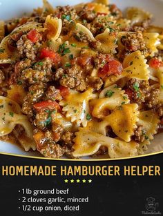 a plate of homemade hamburger helper pasta with ground beef, tomatoes and cheese on top