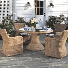 wicker chairs around a round table outside