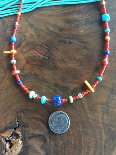 "This cheery, colorful strand of little semiprecious stones, corals and antique African Trade beads is 18 inches long. The semiprecious stones are lapis lazuli, 1 rare gaspeite, green turquoise, blue turquoise. A necklaces similar to this one was called \"Confetti\" in that famous Utah based catalog owned by Robert Redford. There are 3 tiny African Trade Beads, Venetian Stripes - each one 100-200 years old. The center bead is a gorgeous high quality lapis lazuli barrel bead. Sterling Silver lobs Southwestern Single Strand Jewelry Gift, Southwestern Single Strand Jewelry For Gifts, Handmade Southwestern Necklace For Beach, Bohemian Single Strand Round Jewelry, Spiritual Polished Beads Jewelry For Beach, Spiritual Beach Jewelry With Polished Beads, Bohemian Single Strand Pendant Beaded Necklace, Spiritual Polished Beads Necklace For Beach, Festival Single Strand Round Bead Jewelry