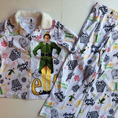 Buddy The Elf Theme Christmas Pajamas. Girls Size Extra Small Xs. New With Tags Sleepwear Set. Button Up Top With Fuzzy White Collar And Cuffs. Silver Sparkle Buttons. Matching Pull On Style Pants With Elastic Waist. Printed With Movie Phrases "Santa Is Coming!" "Smiling Is My Favorite" "Son Of A Nutcracker". Holiday Print With Trees, Snowflakes, Stockings, Gifts, And Snowglobes. 100% Polyester. 8z Smiling Is My Favorite, Son Of A Nutcracker, Santa Is Coming, Striped Pajama Pants, Elf Movie, Disney Toddler, Grey Trench Coat, Favorite Son, Flannel Pajama Sets