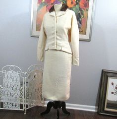 This is a vintage suit from the 1940's. Cream wool with mink collar on the jacket. Jacket is fitted through the front with Dolman-like sleeves and it's a little blousy at the back. Skirt is a straight style that zips and fastens on the side. Has a metal zipper. Skirt is lined in the back half which is often the case in vintage skirts. Estimated as a medium. Jacket fits up to a  38" bust, 32" waist and length is about 21" from the top of shoulder to bottom edge. Skirt fits up to a 28" waist, 40" Classic Winter Semi-formal Skirt Suit, Classic Winter Skirt Suit For Semi-formal Occasions, Classic Fitted Winter Skirt Suit, Classic Fitted Skirt Suit For Winter, Classic Wool Skirt Suit For Winter, Fitted Wool Skirt Suit For Winter, Vintage Winter Skirt Suit For Formal Occasions, Vintage Formal Fall Skirt Suit, Vintage Long Sleeve Skirt Suit For Formal Occasions