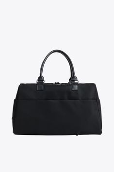 The search for the perfect elevated duffle ends here. This is a durable, sleek bag with multiple exterior pockets, vegan leather details, and interior organization to keep all your business in order. Perfect for when you want to seem like the carefree under-packer, but you actually want room to bring twelve pairs of underwear — just in case. Made from water resistant nylon, you’ll be truly ready for everything with a bag that channels modern design and everyday function. Pairs well with the Fron Practical Business Bags With Zipper Closure, Black Duffle Bag With Pockets For Everyday Use, Everyday Black Duffle Bag With Pockets, Modern Travel Duffle Bag With Zipper Pocket, Versatile Black Travel Bag With Pockets, Black Rectangular Weekender Bag For Business Trips, Modern Travel Duffle Bag, Modern Duffle Bag With Zipper Pocket For Travel, Modern Travel Bag With Zipper Closure For Business Trips