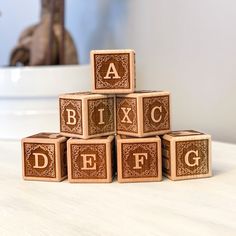 a stack of wooden blocks with letters on them