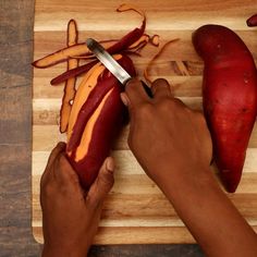 a person cutting up some food on top of a wooden cutting board with a knife