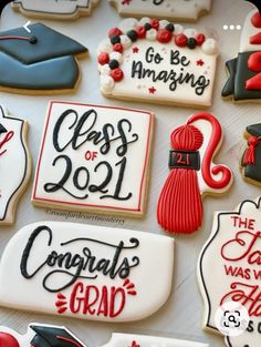 decorated graduation cookies are displayed on a table