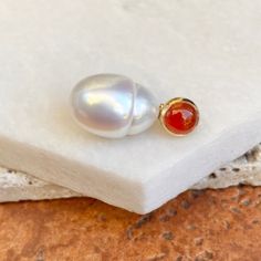 "14KT Yellow Gold Genuine Carnelian Gemstone + Cultured Paspaley South Sea Pearl Pendant Set with (1) 6mm, round, cabochon, bezel set, genuine carnelian gemstone, & (1) Fashion quality, cultured, Paspaley South Sea Pearl 10mm Entire Pendant Measures approx 20mm x 10mm Polished 14KT Yellow Gold Slides on any necklace up to a 3mm or smaller Shown with neck wires, which are NOT included, however can be purchased separately From The Paspaley \"Sea Spirit\" Please take a minute & look at our Elegant Round Amber Beads And Cabochons, Amber Beads And Cabochons For Gift, Round Carnelian Beads For Jewelry Making, Round Amber Beads Gems And Cabochons For Gifts, Carnelian Cabochon Jewelry For Anniversary, Round Amber Beads And Cabochons For Gifts, Elegant Carnelian Gemstones As A Gift, Elegant Carnelian Gemstones As Gifts, Elegant Round Carnelian Jewelry