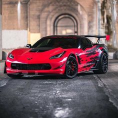 a red sports car parked in front of a building