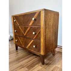 a wooden dresser sitting on top of a hard wood floor