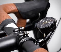 a close up of a bike handlebar with a watch on it