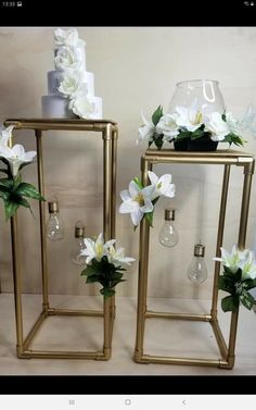 two gold vases with flowers on them