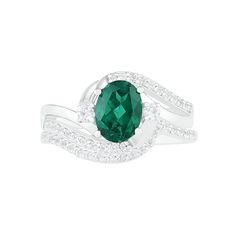 a ring with an oval green stone surrounded by diamonds