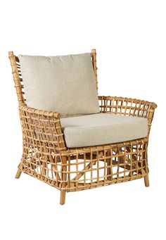 a wicker chair with a cushion on it's back and armrests