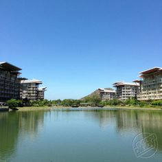 a lake with buildings in the background