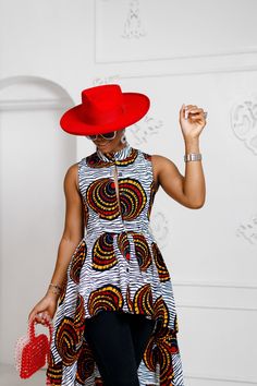 Introducing our hi-lo Ankara blouse, a perfect blend of casual and elegant style. The rich, deep colors and flowy hemline make for a stunning ensemble suitable for any occasion. Pair with jeans or shorts for a unique and eye-catching date night look. Experience the perfect combination of comfort and sophistication. * 100% African Wax Cotton * Front Botton top with Matching detachable belt * Top is UnLined * Side pockets * Model Is Wearing A Size Small and Height is 5'9  CARE INSTRUCTION * Hand W Fitted High-low Hem Tops For Fall, Chic Blouse With Fitted High-low Hem, Trendy High-low Hem Tops For Summer, Trendy Summer Tops With High-low Hem, Chic Summer Tops With Curved Hem, Chic Curved Hem Summer Tops, Fitted Summer Tops With Curved Hem, Fitted Summer Top With Curved Hem, Ankara Blouse