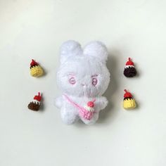 a white stuffed animal surrounded by small crocheted toys