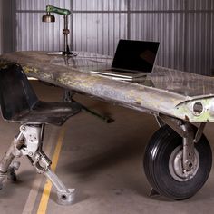 an old metal table with a laptop computer on it's wheels in a garage