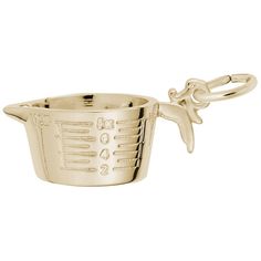 a gold colored measuring cup with a bird on the handle and chain attached to it