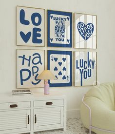 a living room filled with furniture and pictures on the wall next to a white cabinet