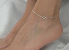 Sterling silver heart and cubic zirconia ankle bracelet, Sterling silver heart crystal anklet, Sweetheart gift This listing is for a beautiful and elegant sterling silver heart and cubic zirconia ankle bracelet. It comprises a solid silver open heart connector with one side encrusted with tiny cz stones. The dainty heart charm attaches to sterling silver chain and closes with a sterling silver clasp. Measurements: 22cm plus 2.5cm extender chain. Custom sizing upon request. The ankle bracelet com Turquoise Ankle Bracelet, Rose Gold Anklet, Heart Jewellery, Crystal Anklet, Silver Heart Bracelet, Bracelet Heart, Sterling Silver Anklet, Gold Anklet, Heart Crystal