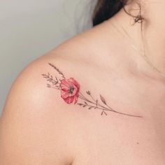 a woman with a flower tattoo on her shoulder