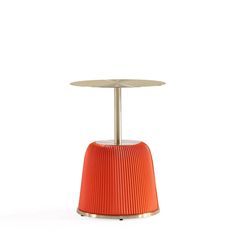 an orange table with a metal base and a round top on the bottom, in front of a white background