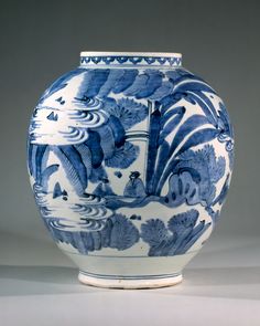 a blue and white vase sitting on top of a table